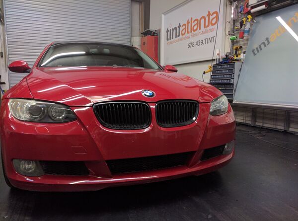 Red BMW Coupe front view with dark window tint by Tint Macon