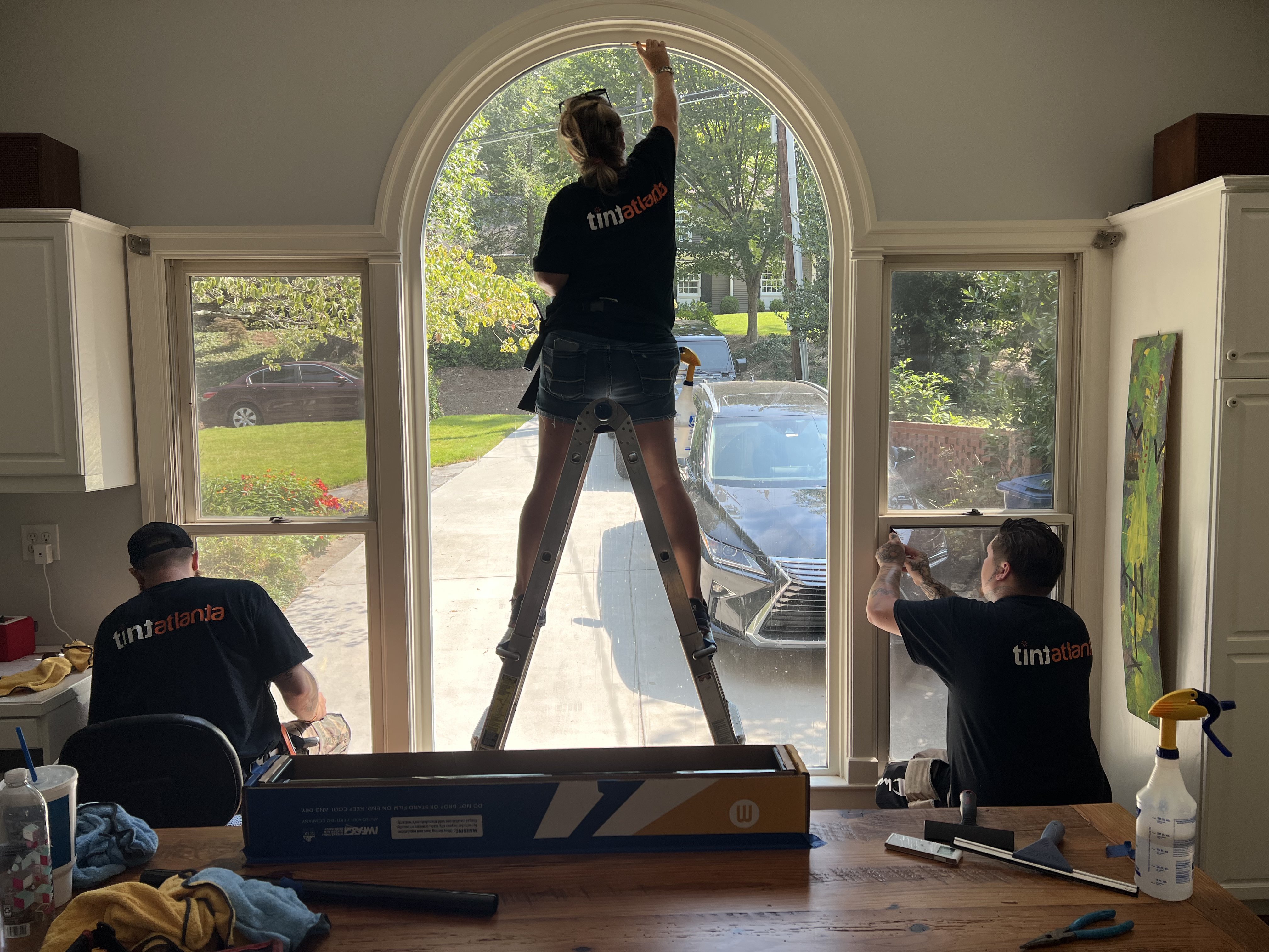 Tint Macon team installing residential window film